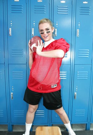 Lady football player prepares for game by posing undressed in locker room
