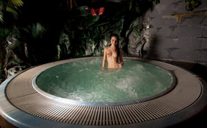 Rather than sleeping petite brunette visits an outdoor jacuzzi in the nighttime