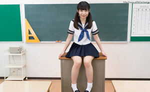 Japanese schoolgirl takes off her panties to show up her clean-shaven cunt