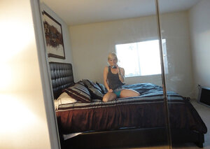 Blonde chick in green underwear takes naked selfies in front of a big mirror