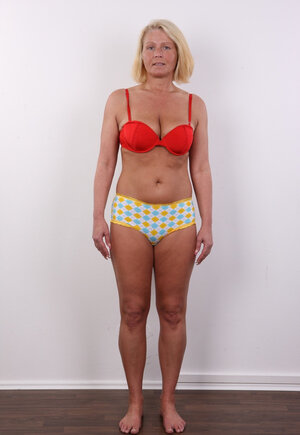 Photographer takes photos of cheerful mature woman with blonde hair