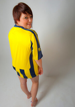 Plumpish football fan pulls T-shirt off to show off her hooters & sexy panties