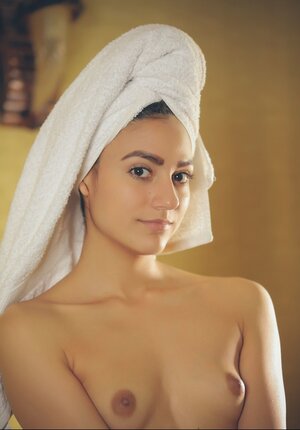 Hoe with a towel on head and furthermore in white robe gives sexual pleasure to pussy