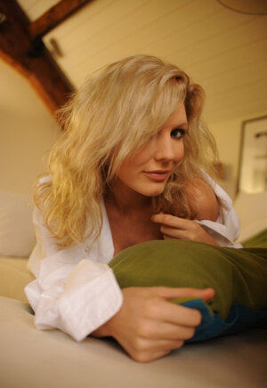 Adorable blonde lassie sensually strips naked to expose her charming immature body