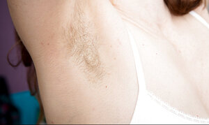 Gal with red hair and also unshaved armpits does her morning exercises