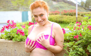 Ginger sweetheart with shaggy bush strips to show her milk sacks by the pool