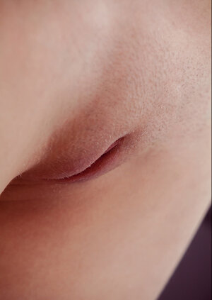 Slender slut reveals private parts in her bed in front of the window