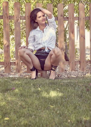 Attractive young belle doffs clothes to tempt with her perfect tits outdoors