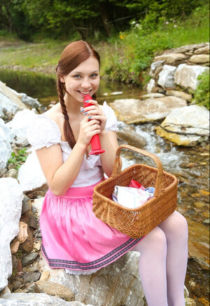 Redhead teeny with pigtails pulled down panties to play with toy outdoors