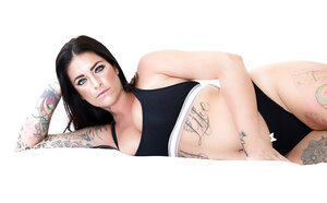 Spanish brunette with hefty chest & buttocks exposes tattooed body