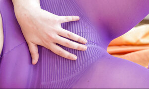 Curly babe with short hair shows hairy twat that is hidden under purple pantyhose