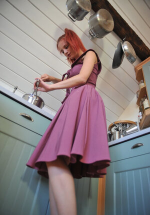 Pretty redhead doffs clothes and besides gets nasty for the camera in the kitchen