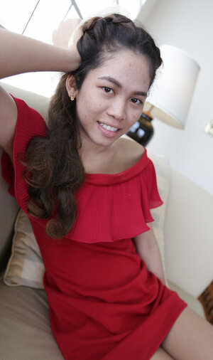 Thai whore in a red dress never stops smiling even in the backseat of a taxi
