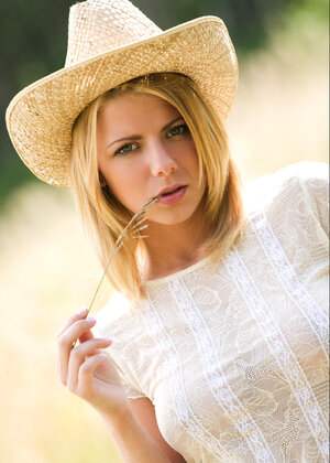 Hot blonde strips down to pose undressed not far from her farm