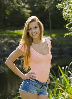 Alexis Crystal unclothes and besides poses seductively outdoors